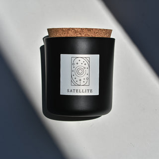 Satellite candle in black apothecary glass with cork top.