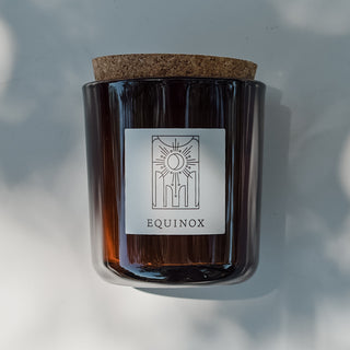 Equinox amber glass candle with cork top.