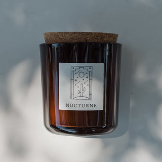 Nocturne candle in amber glass with cork top.