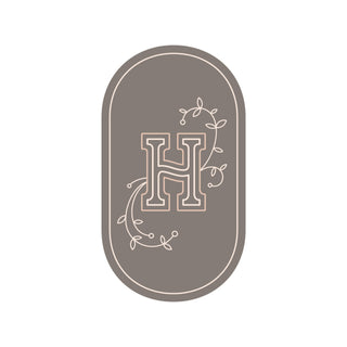 clay oval H logo with tendrils on either side
